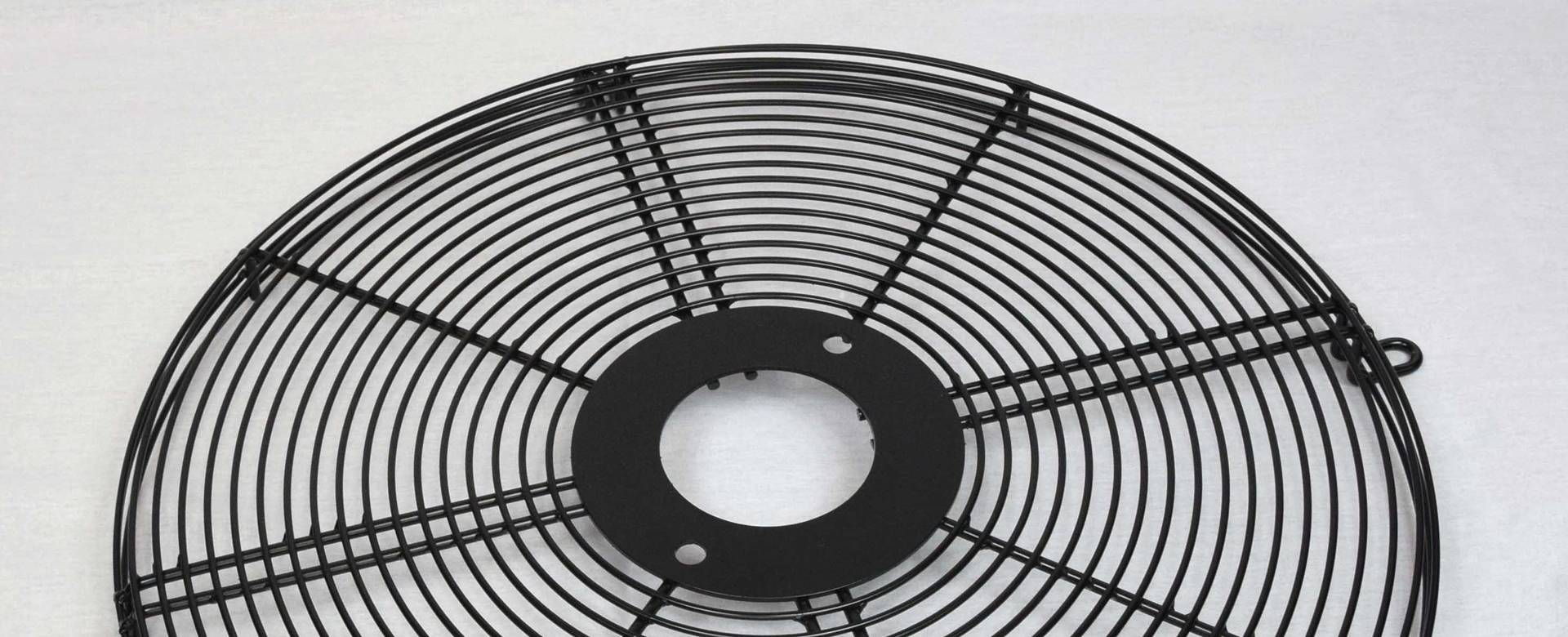 A black dome fan guard with thick metal wire.